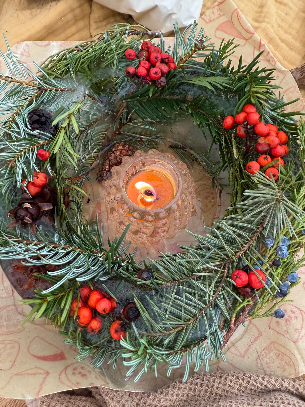 This is actually an ice mold, but showcases multiple evergreens, pine cones, and rowan and juniper berries.